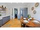 Eat-in kitchen features gray cabinets, stainless steel refrigerator, hardwood floors, and decorative open shelving at 419 N College Ave, Indianapolis, IN 46202
