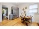 Bright eat-in kitchen featuring gray cabinets, stainless steel refrigerator, and hardwood floors at 419 N College Ave, Indianapolis, IN 46202
