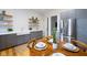 Eat-in kitchen features stainless steel appliances, gray cabinets, and a round table set for four at 419 N College Ave, Indianapolis, IN 46202