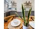 Stylish kitchen features white subway tile, gray cabinets, floating shelves, and wooden dining table at 419 N College Ave, Indianapolis, IN 46202