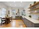 Bright kitchen features stainless steel appliances, gray cabinets, subway tile, and dining table at 419 N College Ave, Indianapolis, IN 46202
