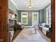 Elegant living room featuring a decorative fireplace, stylish furnishings, hardwood floors, and plenty of natural light at 419 N College Ave, Indianapolis, IN 46202