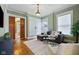 Stylish living area with dark wood sliding doors, hardwood flooring, and large windows at 419 N College Ave, Indianapolis, IN 46202