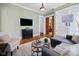 Bright living room featuring a large TV, plush seating, and seamless flow to other spaces at 419 N College Ave, Indianapolis, IN 46202