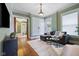 Bright living room featuring hardwood floors, comfortable seating, natural light, and stylish accents at 419 N College Ave, Indianapolis, IN 46202