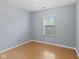 Bedroom with a window offering a view of the outdoors and wood-look flooring creating a comfortable space at 4195 Knollwood Ct, Franklin, IN 46131