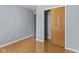 Bedroom with light walls, wood-look flooring, and a closet, creating a simple and clean aesthetic at 4195 Knollwood Ct, Franklin, IN 46131