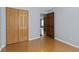 Well-lit bedroom with double closets and wood look floors and light walls creating a calming atmosphere at 4195 Knollwood Ct, Franklin, IN 46131