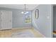 Bright dining area featuring a chandelier, large window, and a decorative mirror at 4195 Knollwood Ct, Franklin, IN 46131