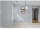 Bright dining area featuring a chandelier, large window, and light blue walls at 4195 Knollwood Ct, Franklin, IN 46131