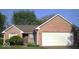 Charming brick home features an attached two-car garage and a well-maintained, verdant front yard at 4195 Knollwood Ct, Franklin, IN 46131
