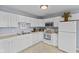 Functional kitchen with appliances and white cabinetry at 4195 Knollwood Ct, Franklin, IN 46131