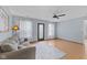 Spacious living room featuring wood-look floors, light walls, a ceiling fan, and natural light at 4195 Knollwood Ct, Franklin, IN 46131