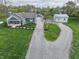 Aerial view of a well-landscaped blue house with a detached garage, shed, and a long, winding gravel driveway at 4284 E County Road 100 S, Avon, IN 46123