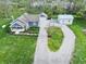 Aerial view of a charming blue house, garage, storage building, and a lush green yard at 4284 E County Road 100 S, Avon, IN 46123