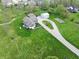 Bird's eye view of a blue home with a large lawn, detached garage, shed, vegetable garden, and gravel driveway at 4284 E County Road 100 S, Avon, IN 46123
