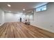 This finished basement features recessed lighting, wood-look flooring, and a large wall mirror at 4284 E County Road 100 S, Avon, IN 46123