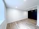 Finished basement with sleek wood flooring, a window, and a modern black storage unit at 4284 E County Road 100 S, Avon, IN 46123