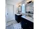 Bathroom with dual vanities, decorative tile floor and a large window at 4284 E County Road 100 S, Avon, IN 46123