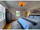 Bedroom features a queen-sized bed, hardwood floors, a large rug, and natural light at 4284 E County Road 100 S, Avon, IN 46123