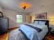 Cozy bedroom with a large rug, and natural light filtering through a window overlooking the front yard at 4284 E County Road 100 S, Avon, IN 46123