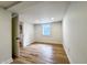 This spare bedroom features wood-look floors, a window, and a door that leads to a utility space at 4284 E County Road 100 S, Avon, IN 46123