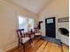Cozy entryway featuring hardwood floors, a black front door, and vintage-style furniture under a window at 4284 E County Road 100 S, Avon, IN 46123
