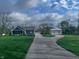 Charming blue home with a well-maintained lawn and a long, gravel driveway leading to a detached garage and shed at 4284 E County Road 100 S, Avon, IN 46123
