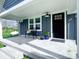 Inviting front porch with a comfortable bench, potted plants, and a black front door, offering a cozy welcome at 4284 E County Road 100 S, Avon, IN 46123