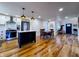 Open concept kitchen with modern appliances, a center island, hardwood floors, and a dining area, perfect for entertaining at 4284 E County Road 100 S, Avon, IN 46123