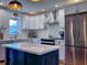 Well-lit kitchen featuring stainless steel appliances, white cabinetry and a large island with a white countertop at 4284 E County Road 100 S, Avon, IN 46123