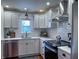 Modern kitchen with white cabinets, stainless steel appliances, quartz countertops, and subway tile backsplash at 4284 E County Road 100 S, Avon, IN 46123