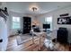 Home office featuring hardwood floors, a large area rug, a desk and natural light at 4284 E County Road 100 S, Avon, IN 46123