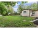Exterior of home, showcasing the lush green backyard and mature trees at 4432 Brittany Rd, Indianapolis, IN 46222