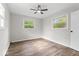Bedroom featuring wood-look flooring, a ceiling fan, and large windows for ample natural light at 4432 Brittany Rd, Indianapolis, IN 46222