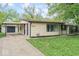 View of home with carport, featuring a concrete driveway and a well-manicured lawn at 4432 Brittany Rd, Indianapolis, IN 46222