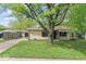 Charming single-story home with a carport, featuring a well-maintained lawn and mature trees at 4432 Brittany Rd, Indianapolis, IN 46222