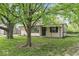 Charming single-story home featuring a well-maintained lawn and mature trees in a peaceful neighborhood at 4432 Brittany Rd, Indianapolis, IN 46222