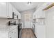 Bright kitchen featuring white cabinets, granite countertops, stainless steel appliances, and wood-look flooring at 4432 Brittany Rd, Indianapolis, IN 46222