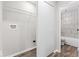 A combined laundry room and bathroom with shelving and tiled shower/tub at 4432 Brittany Rd, Indianapolis, IN 46222