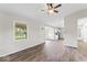 Open-concept living area with new flooring and modern fixtures flowing into a well-lit kitchen at 4432 Brittany Rd, Indianapolis, IN 46222