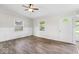 Bright living room with hardwood floors, new paint, modern ceiling fan, and natural light from multiple windows at 4432 Brittany Rd, Indianapolis, IN 46222