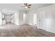 Spacious living area with hardwood floors leading to a modern kitchen and hallway with doors at 4432 Brittany Rd, Indianapolis, IN 46222