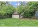 Exterior view of shed, surrounded by mature trees and lush grass at 4432 Brittany Rd, Indianapolis, IN 46222