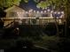 Back deck of the house with hanging string lights in the trees, creating a peaceful outdoor space for entertaining at 448 Tamarack Ln, Noblesville, IN 46062