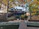Exterior of lake home from the water, featuring a tiered deck and stone details, perfect for outdoor enjoyment at 448 Tamarack Ln, Noblesville, IN 46062