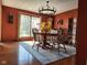 Dining room with hardwood floors, large window, wooden furniture, and chandelier providing an elegant dining experience at 448 Tamarack Ln, Noblesville, IN 46062