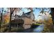 Exterior of a two-story home surrounded by mature trees, a deck, a two-car garage, and a long driveway at 448 Tamarack Ln, Noblesville, IN 46062