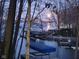 Beautiful view of docks on the lake at dusk, framed by trees, offering serene waterfront living at 448 Tamarack Ln, Noblesville, IN 46062