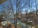 Scenic lake view with a few houses and docks in the background, offering a glimpse of peaceful waterfront living at 448 Tamarack Ln, Noblesville, IN 46062